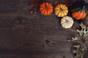 autumn-leaves-and-pumpkins-on-wood-tabletop